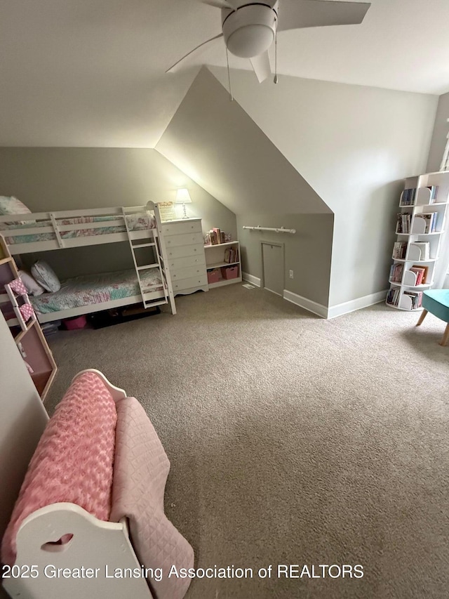 bedroom with a ceiling fan, carpet, vaulted ceiling, and baseboards