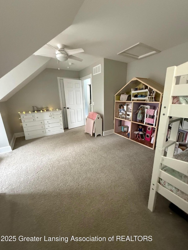 carpeted bedroom featuring attic access, lofted ceiling, and visible vents