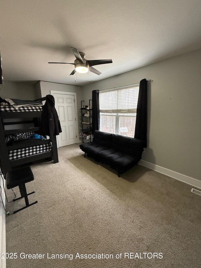 bedroom featuring a ceiling fan, carpet, visible vents, and baseboards