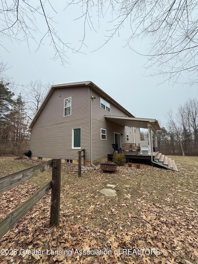 view of side of home with a wooden deck