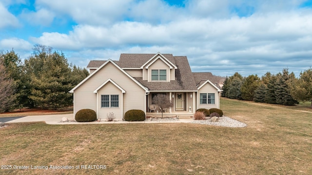 traditional home featuring covered porch, roof with shingles, and a front yard