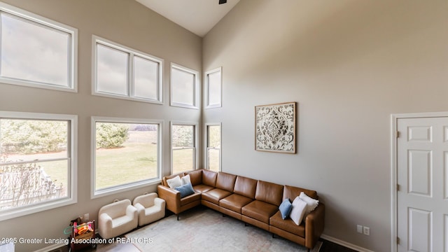 living room featuring a towering ceiling