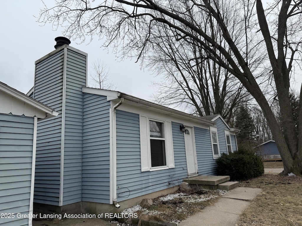 view of side of property featuring a chimney