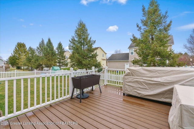 wooden deck with a yard and fence