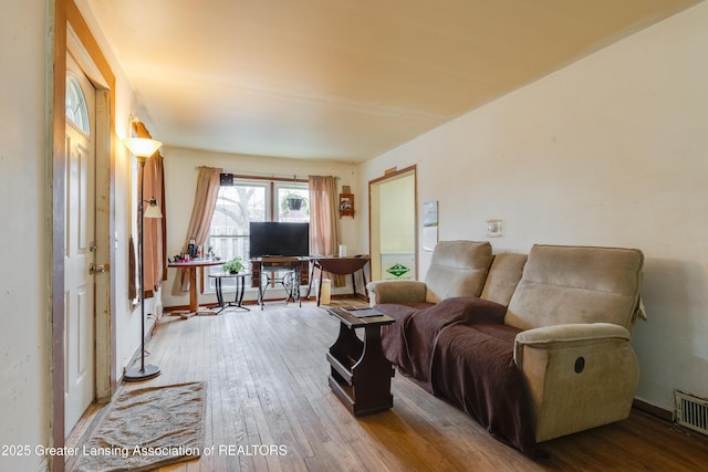 living room featuring visible vents and hardwood / wood-style flooring