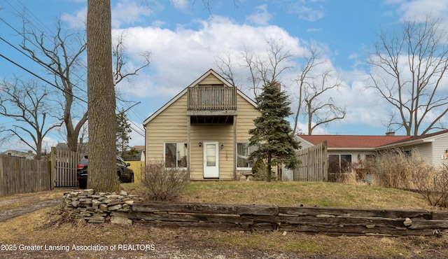 back of house with fence and a balcony