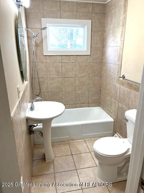 bathroom featuring tile walls, tile patterned flooring, shower / bathing tub combination, and toilet