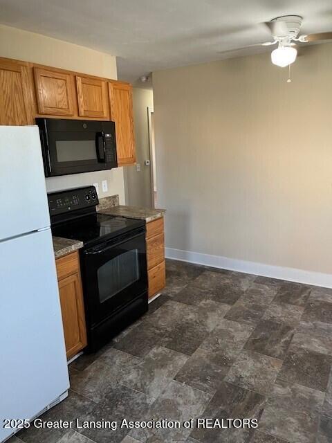 kitchen featuring baseboards, ceiling fan, black appliances, and brown cabinets