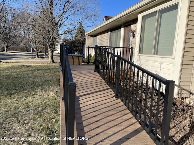 wooden deck featuring a yard