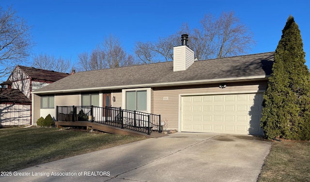 view of front of home with a garage, driveway, a chimney, and roof with shingles