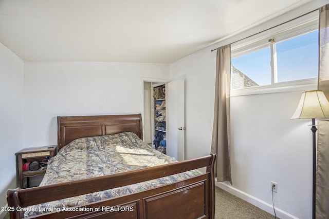 bedroom featuring carpet floors and baseboards