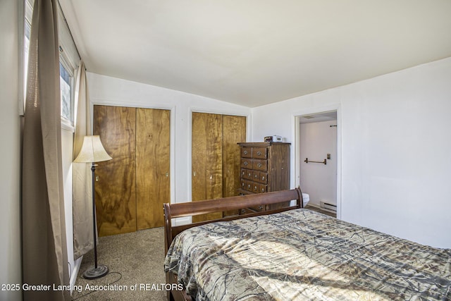 carpeted bedroom featuring multiple closets, lofted ceiling, and a baseboard heating unit