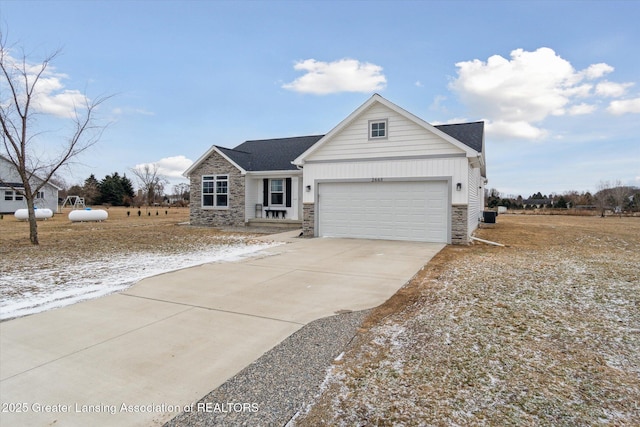 view of front of property with board and batten siding, concrete driveway, an attached garage, and stone siding