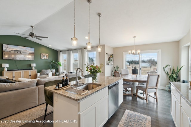 kitchen with a healthy amount of sunlight, dishwasher, open floor plan, and a sink