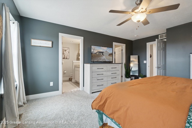 carpeted bedroom with ensuite bathroom, ceiling fan, visible vents, and baseboards