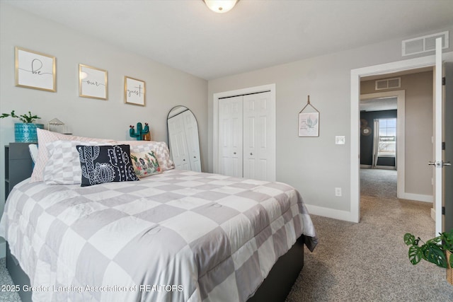 carpeted bedroom with a closet, visible vents, and baseboards