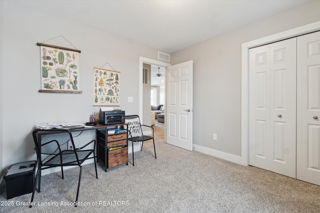 carpeted office featuring baseboards and visible vents