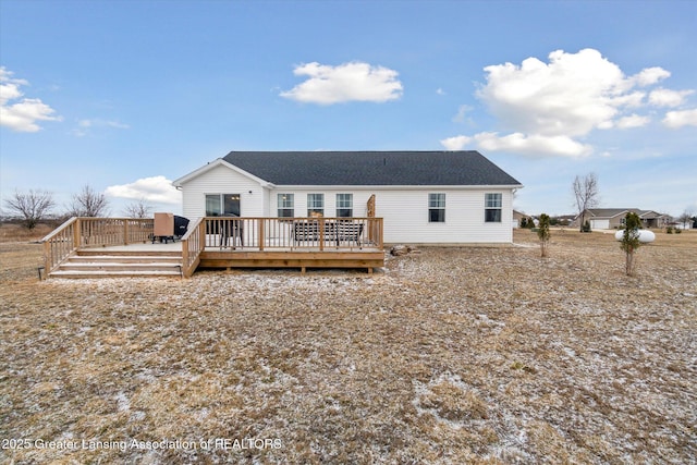 back of property with a wooden deck