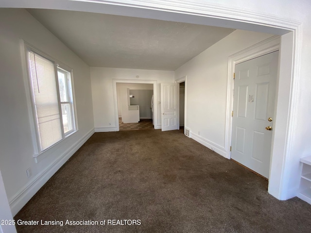 interior space with baseboards, carpet floors, and a closet