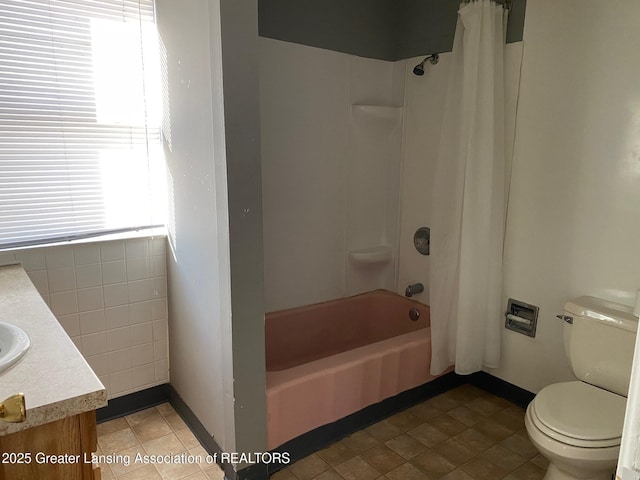 full bathroom featuring vanity, shower / tub combo, and toilet