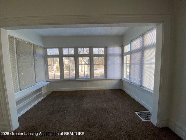 unfurnished sunroom with visible vents