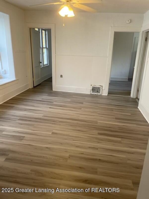 spare room with visible vents, light wood-style floors, and a ceiling fan