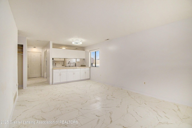 bathroom with a closet, marble finish floor, and vanity