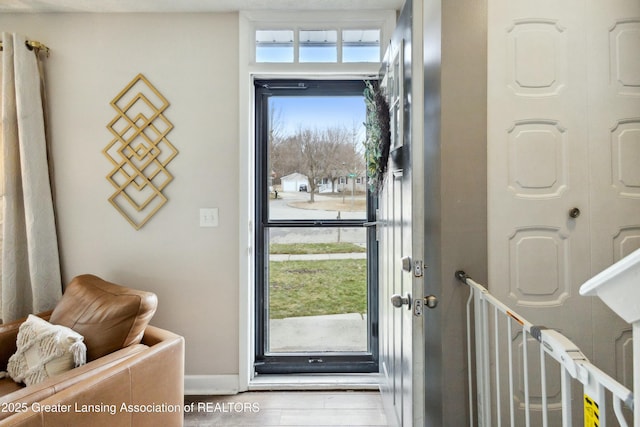 foyer featuring baseboards