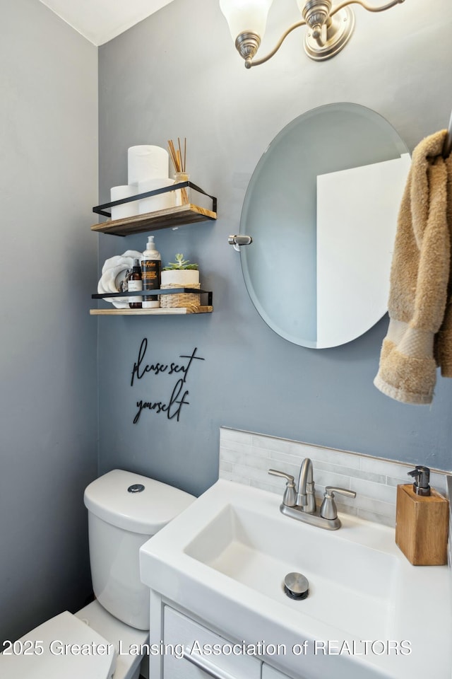 bathroom with toilet and vanity