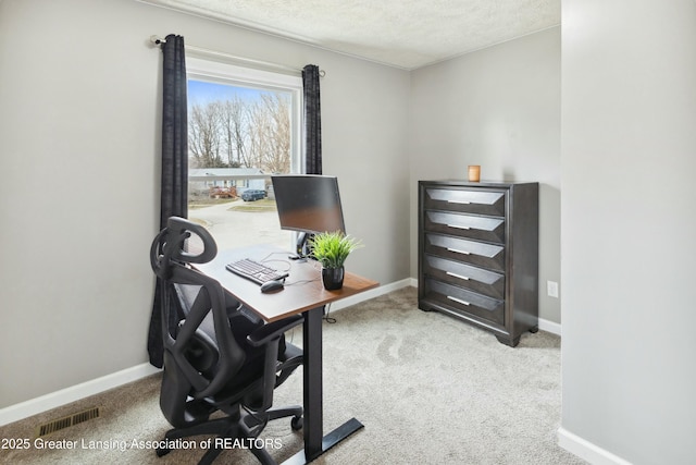 office area featuring visible vents, baseboards, and carpet floors