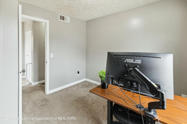 carpeted home office with baseboards, visible vents, and a textured ceiling