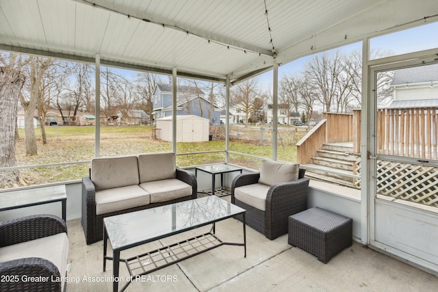 sunroom featuring a healthy amount of sunlight and a residential view