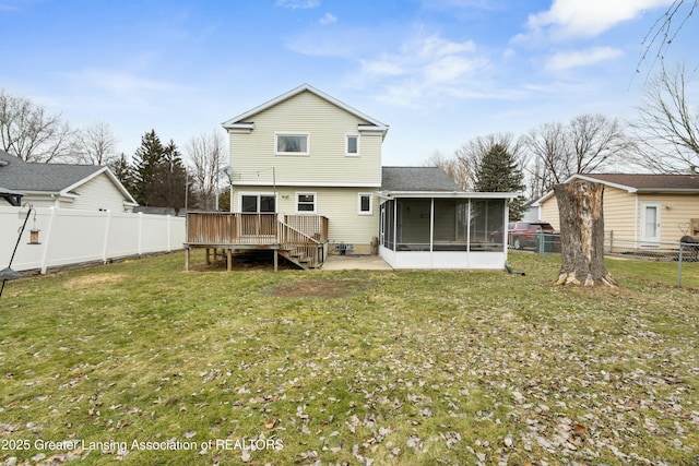 back of house with a yard, a wooden deck, a fenced backyard, and a sunroom