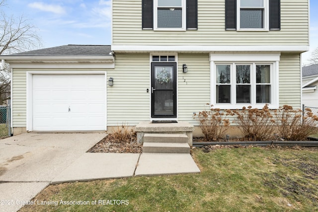 view of front of house featuring a front lawn, concrete driveway, a garage, and roof with shingles