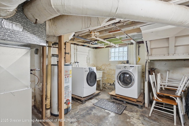 laundry area with heating unit, washing machine and clothes dryer, water heater, and laundry area