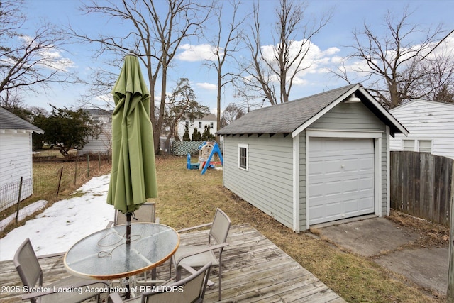 detached garage featuring fence