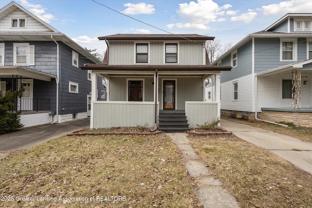 american foursquare style home with covered porch