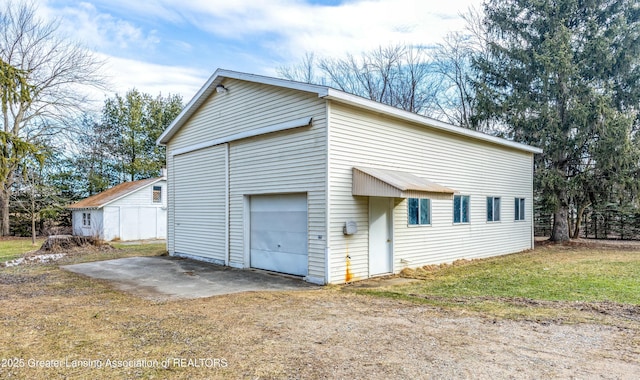 garage with dirt driveway