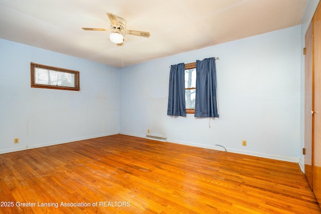 spare room featuring visible vents, light wood-style flooring, baseboards, and a ceiling fan