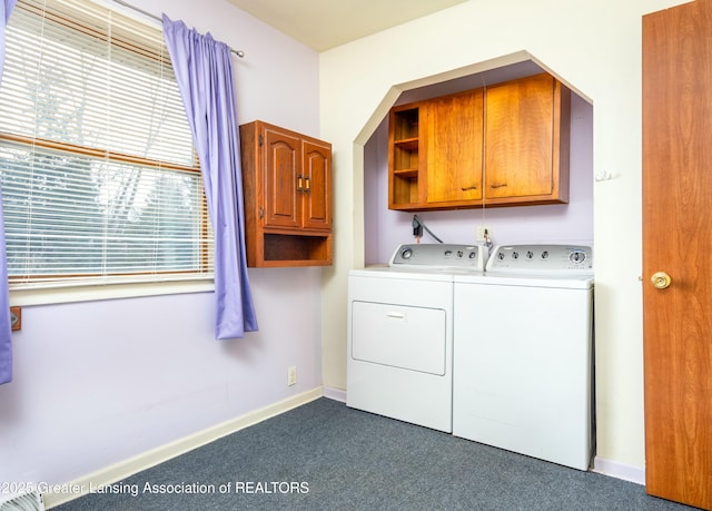 laundry room featuring washer and dryer, baseboards, cabinet space, and dark carpet