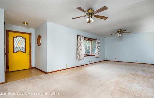 empty room featuring ceiling fan, baseboards, and carpet floors