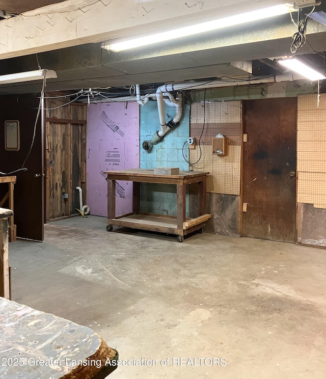 unfinished basement with a workshop area