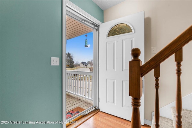 entryway with stairway and wood finished floors