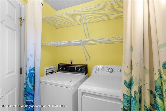 washroom featuring separate washer and dryer and laundry area