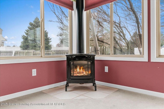 room details featuring a wood stove and baseboards