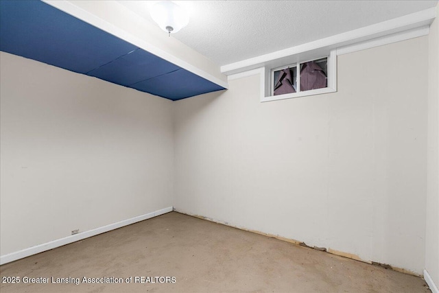 interior space featuring concrete flooring and a textured ceiling