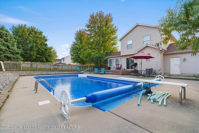 view of pool featuring a fenced in pool, a wooden deck, a water slide, and fence private yard