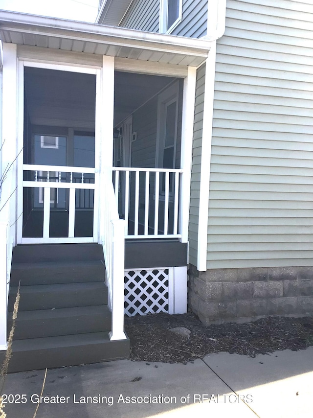 doorway to property featuring covered porch