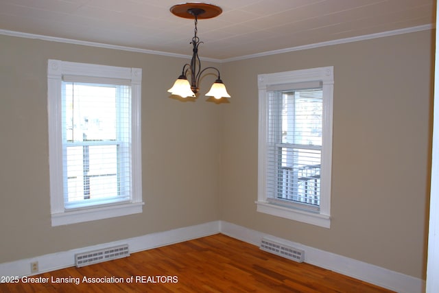 spare room featuring a chandelier, visible vents, and a wealth of natural light