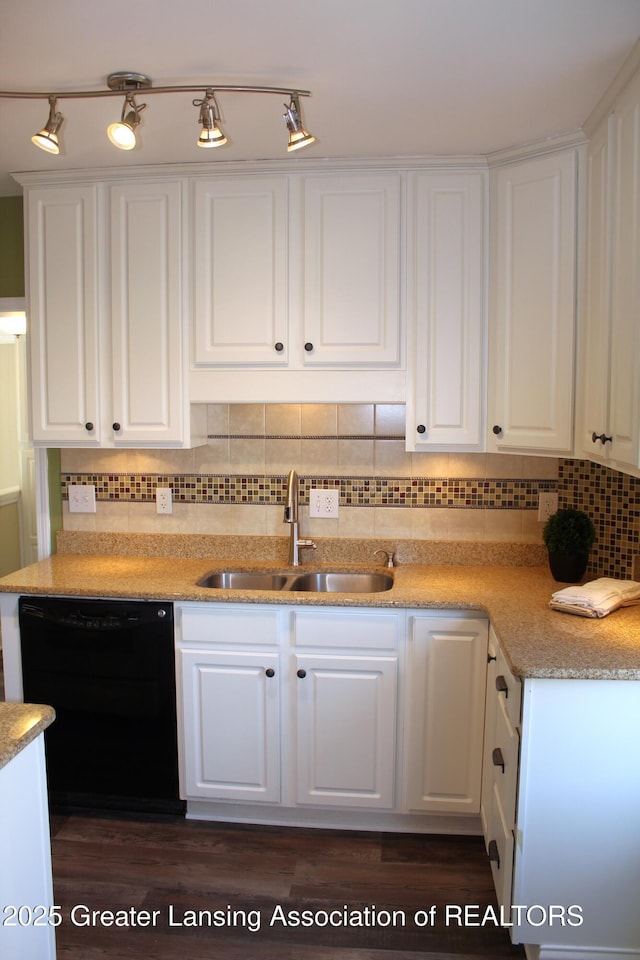 kitchen featuring a sink, backsplash, white cabinets, light stone countertops, and dishwasher